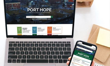 Person on laptop and phone browsing the new Port Hope website